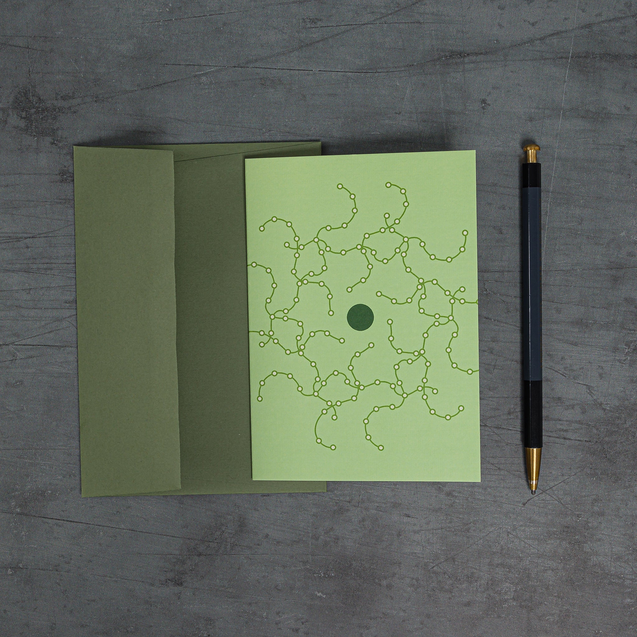 Orbit 1 greeting card - green colour scheme, with coordinated G F Smith envelope. Design: geometric motif resembling tentacular circuitry orbiting a dark green disc