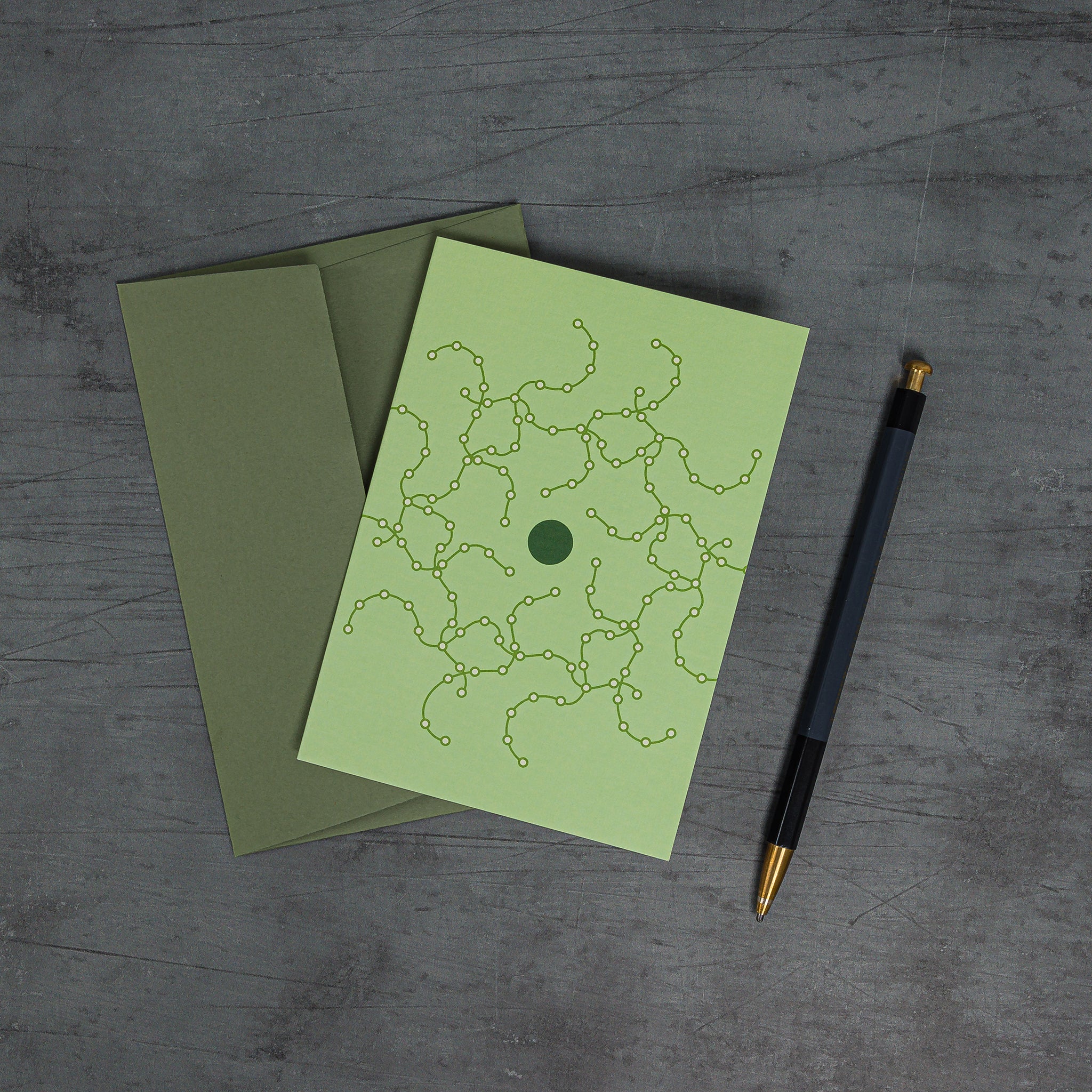 Orbit 1 greeting card, slanting overhead view, green tones with coordinated sage green envelope
