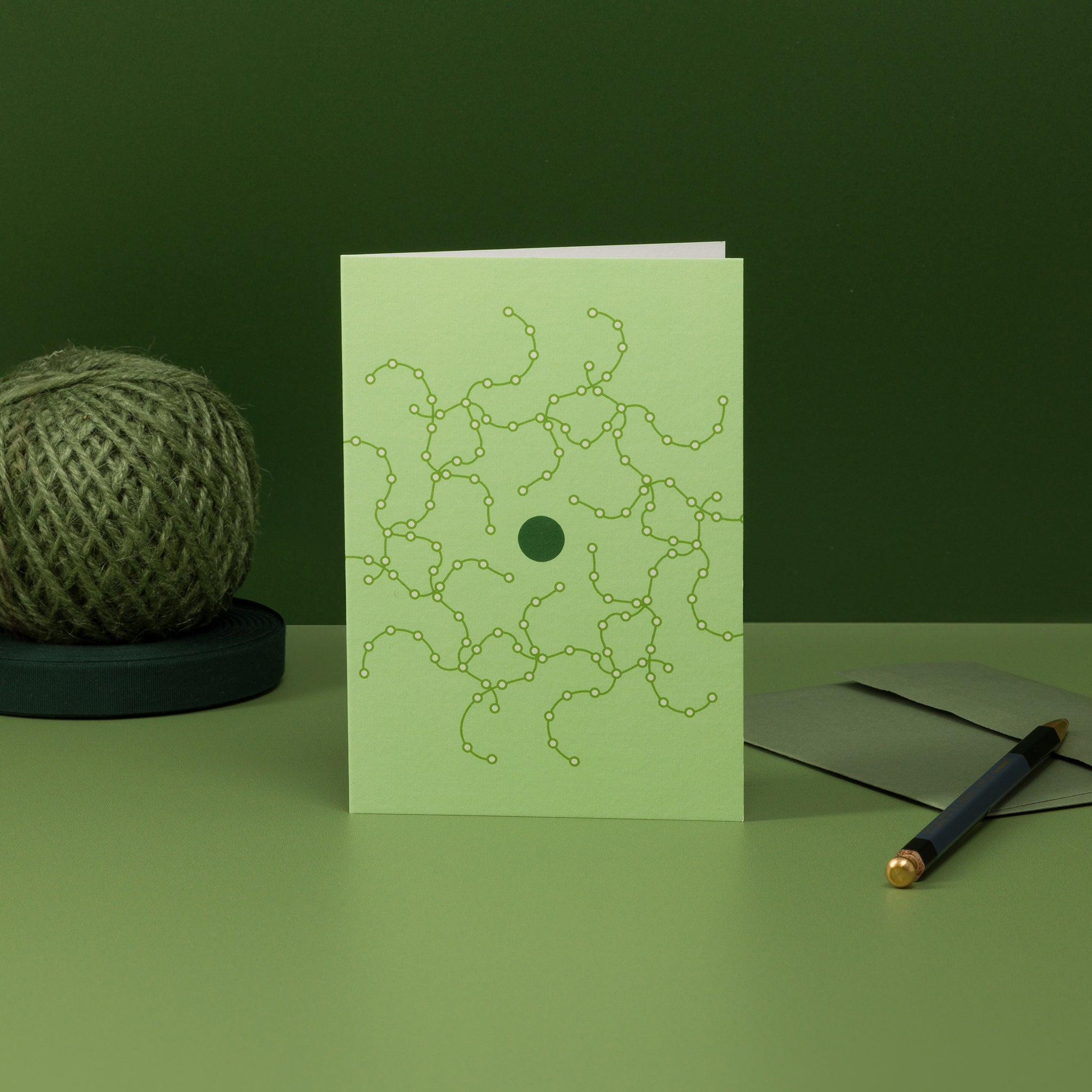 Orbit 1 greeting card - green colour scheme, geometric design resembling tentacular circuitry orbiting a central disc