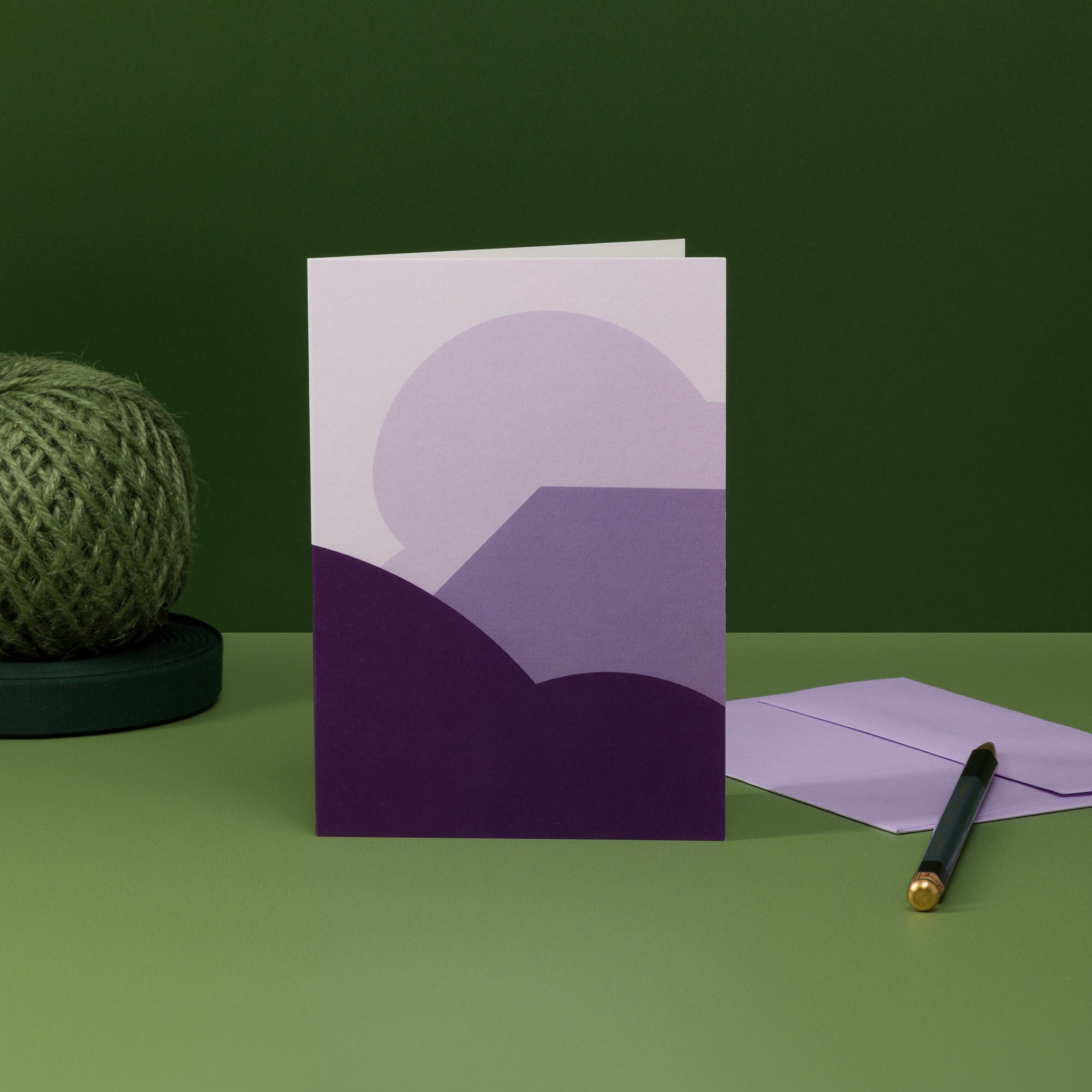 Stack (purple) greeting card with coordinating lilac envelope. Design: a stack of geometric angles and curves, redolent of landscape