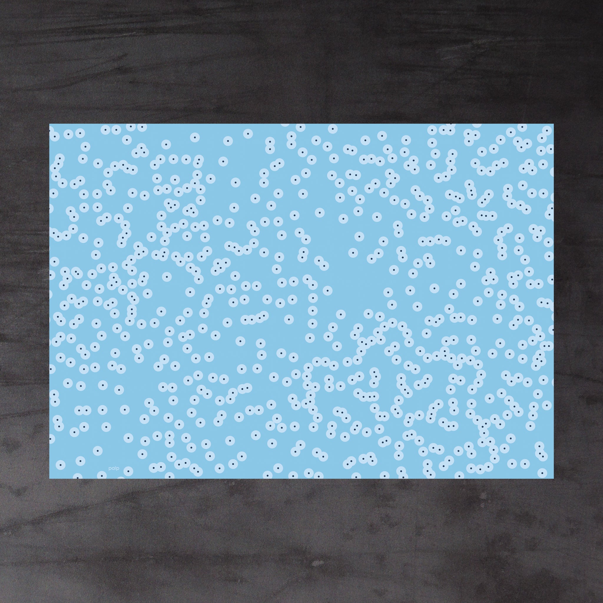 Aerial view of whole sheet of Spawn (blue) wrapping paper. Pattern: irregular clusters of circle motifs, resembling frog spawn in a shallow pond