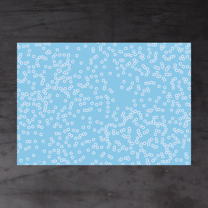Aerial view of whole sheet of Spawn (blue) wrapping paper. Pattern: irregular clusters of circle motifs, resembling frog spawn in a shallow pond
