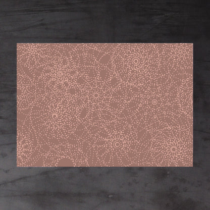 Aerial view of whole sheet of Synapse wrapping paper. Design: overlapping circles with dotted lines, radiating outwards to suggest both plant forms and neurological activity. Beige and peach colour scheme